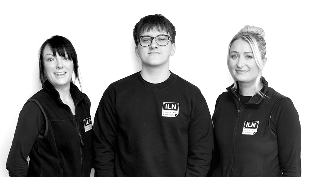 Three members of the Industrial Labels & Nameplates team in branded workwear
